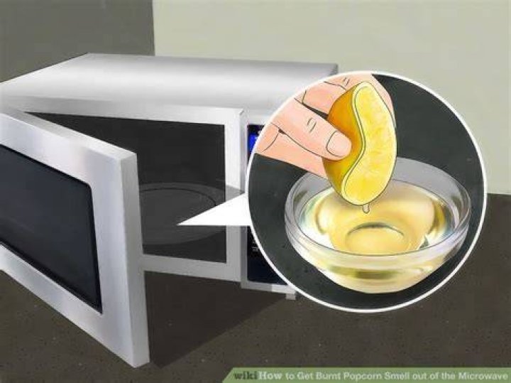 How do I get the burnt popcorn smell out of my microwave?