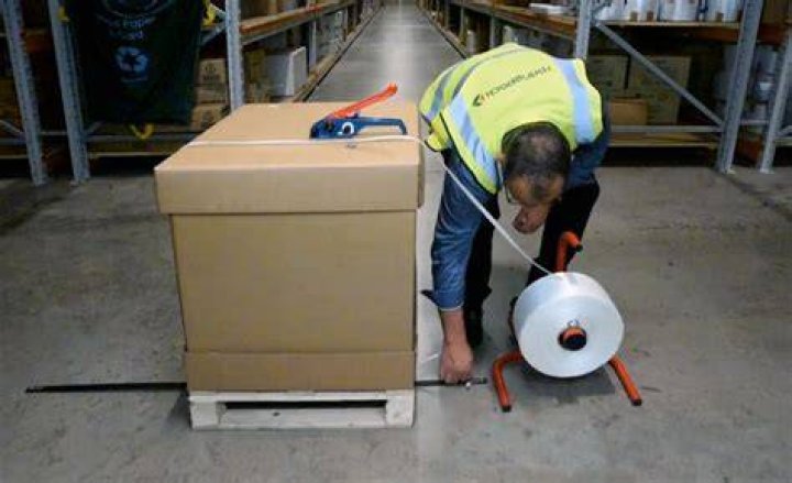 How do you use a strapper on a pallet?